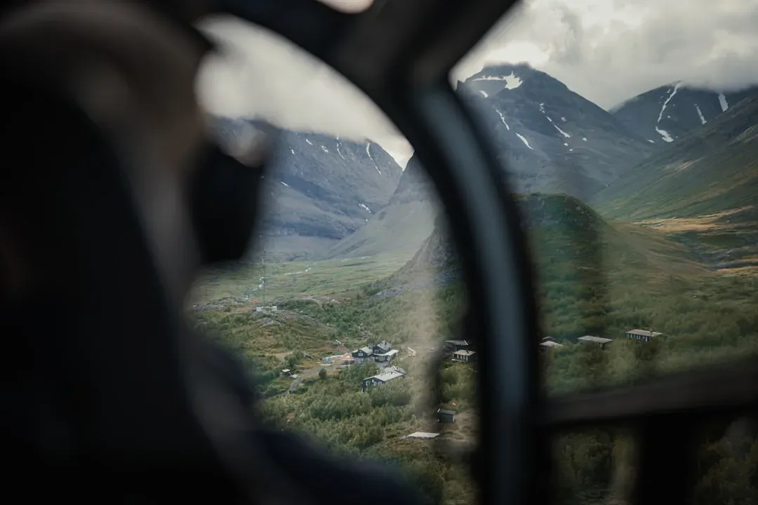 a bus driving through a mountainous region with scenic views